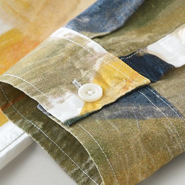 A buttoned cuff in olive and ochre tones.