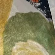 Close-up of a moss green brushstroke on the cotton.